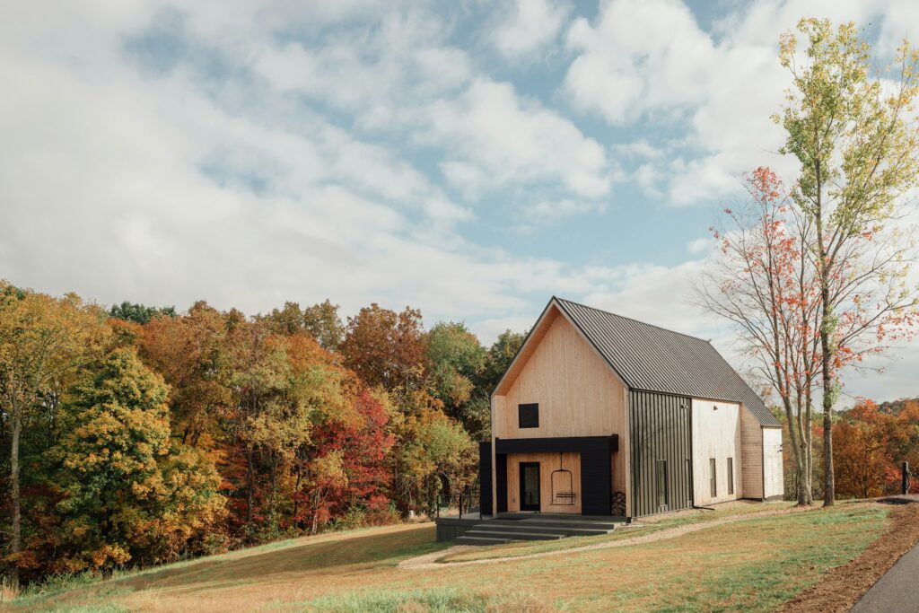 A small modern home at the edge of a field